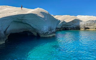 Beautiful rock formation jutting out from the blue waters of Milos island, Greece.